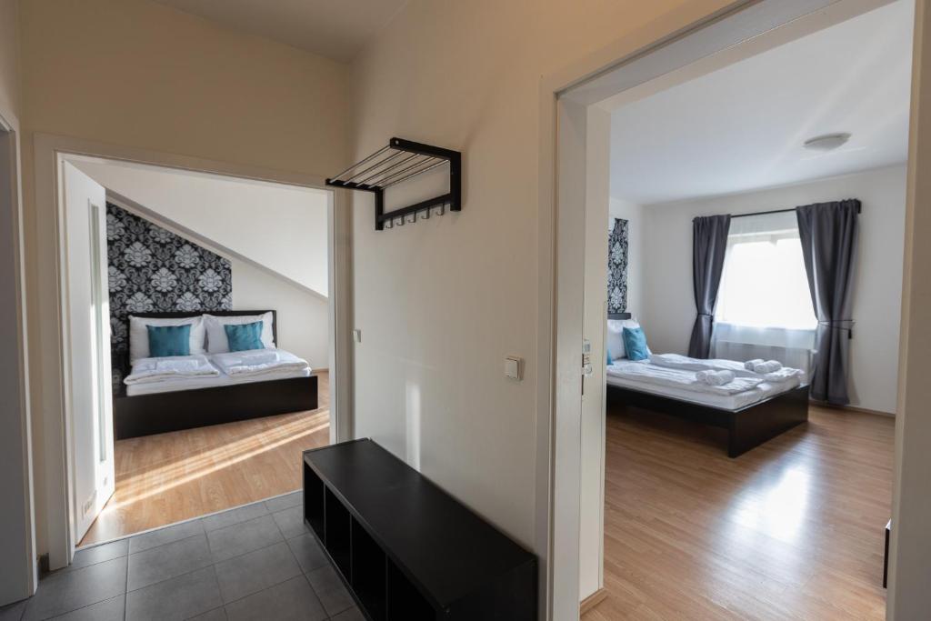 a living room with two beds and a window at Andel Centre SPIRIT in Prague