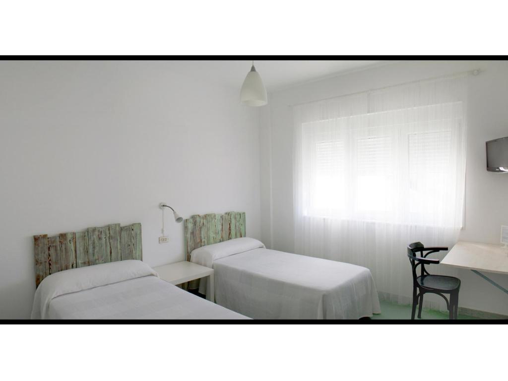 Postel nebo postele na pokoji v ubytování Hotel Langosteira