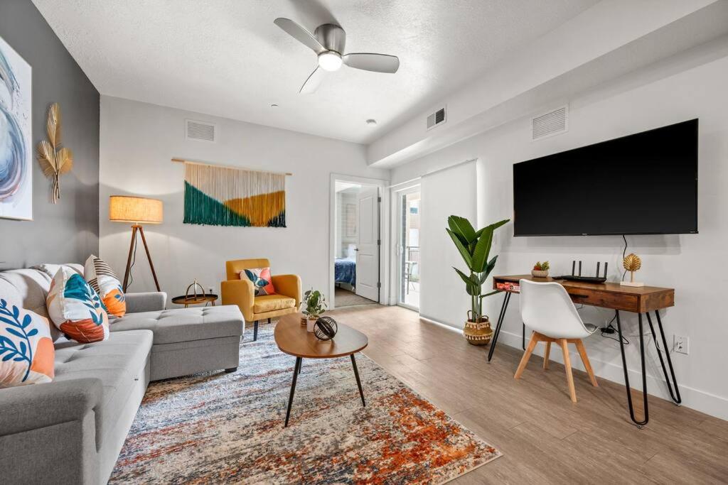 a living room with a couch and a flat screen tv at Luxurious Retreat in SLC in Salt Lake City