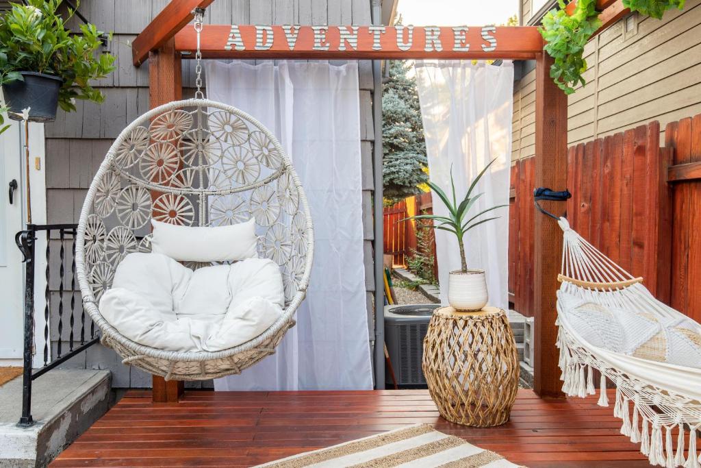 a porch with a swinging chair on a patio at Boise White Water Guest House in Boise