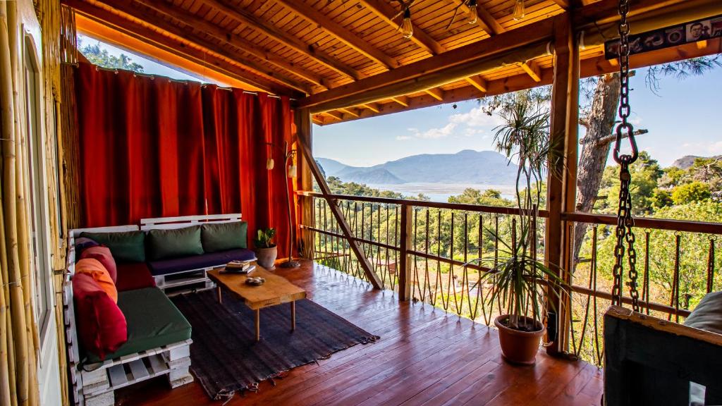 a screened in porch with a couch and a table at Olabilir Houses in Ortaca