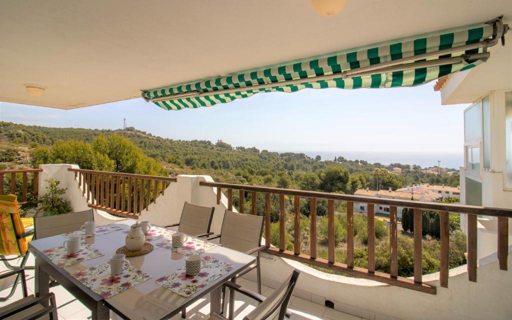a balcony with a table and chairs and a view at Terraza con vistas espectaculares - Haciendas ALBERT VILLAS Alcossebre in Alcossebre
