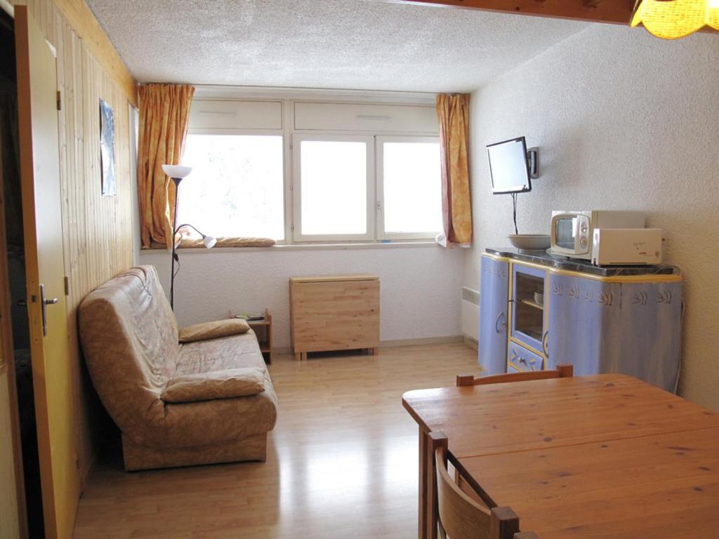 a living room with a chair and a table at Appartement Villard-de-Lans, 2 pièces, 6 personnes - FR-1-515-29 in Villard-de-Lans