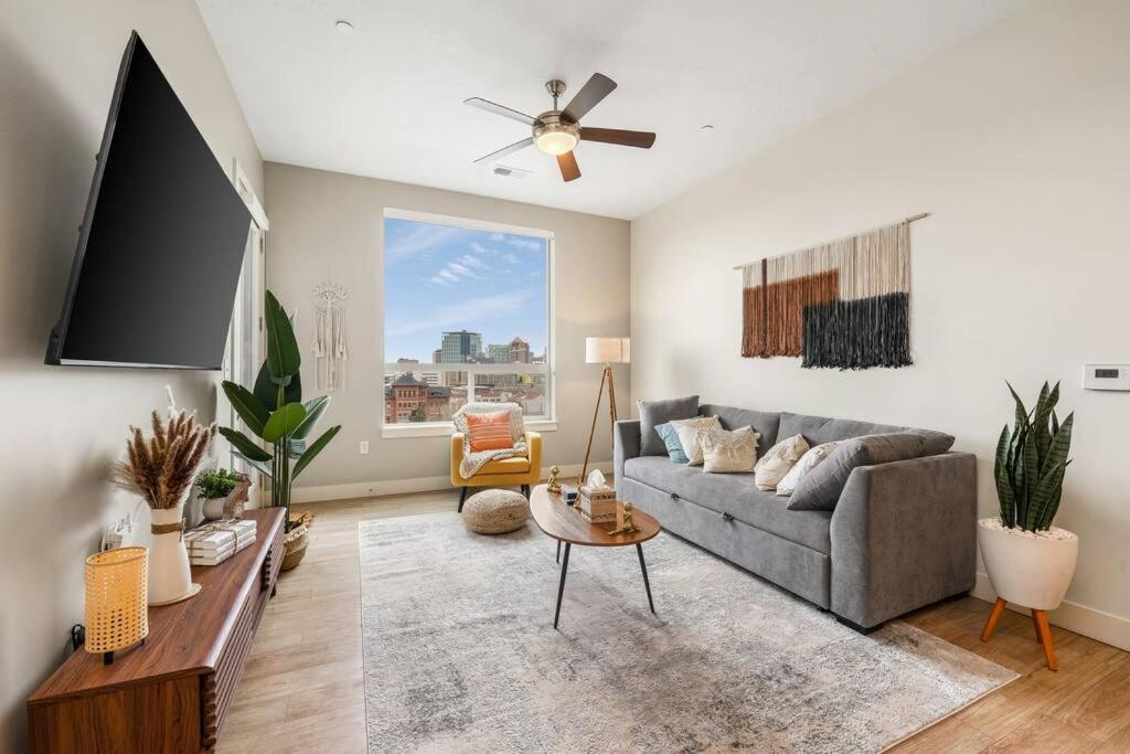 a living room with a couch and a flat screen tv at King BD - City View - Downtown Walking Paradise in Salt Lake City