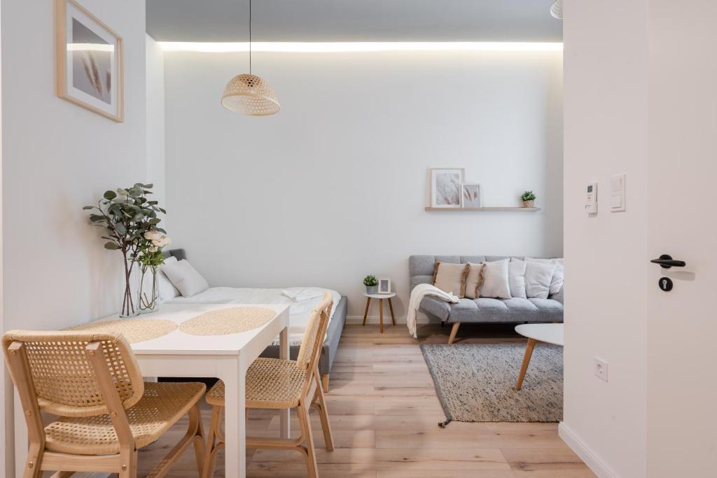a living room with a table and a couch at A62 - Akácfa Street Central Residence - Best Location by BQA in Budapest