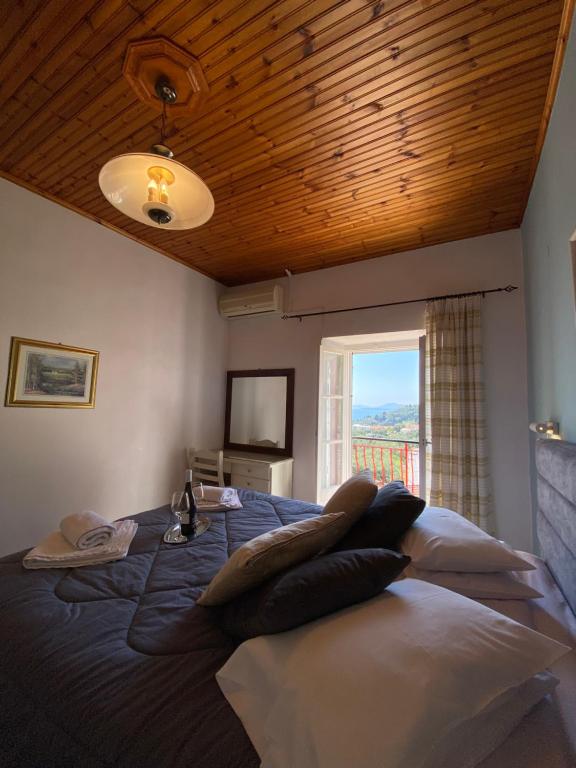 a bedroom with a large bed with a window at Villa Chrysoula in Kalami