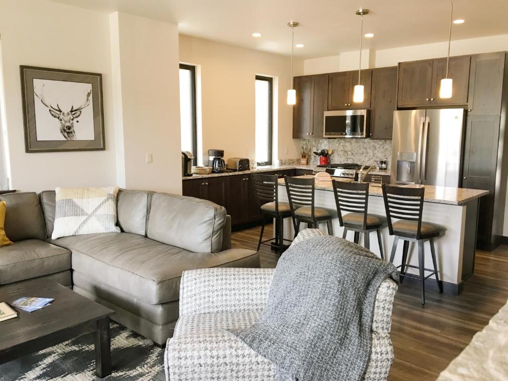 a living room with a couch and a kitchen at Arrow at Winter Park Unit 284 in Winter Park