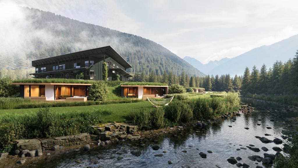 a house in the mountains next to a river at nancy's Holiday Homes Dolomites in Rasùn di Sotto