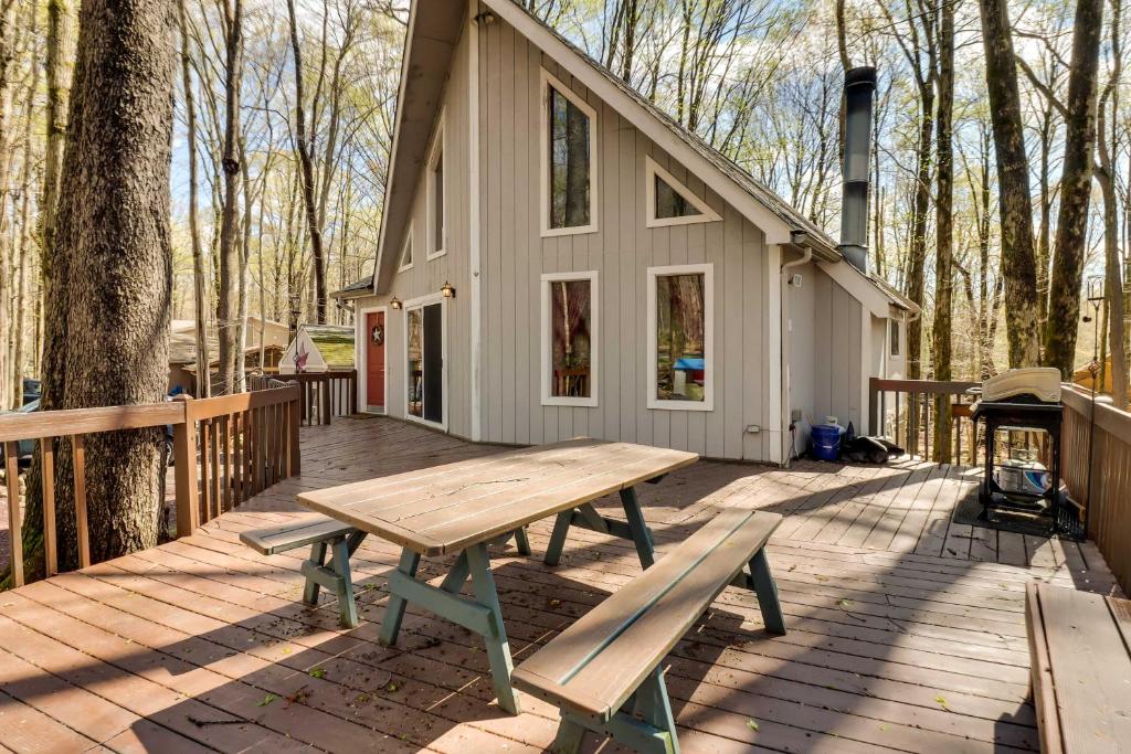 a picnic table on the deck of a cabin at Spacious Pocono Lake House Near Skiing and Swimming! in Pocono Lake