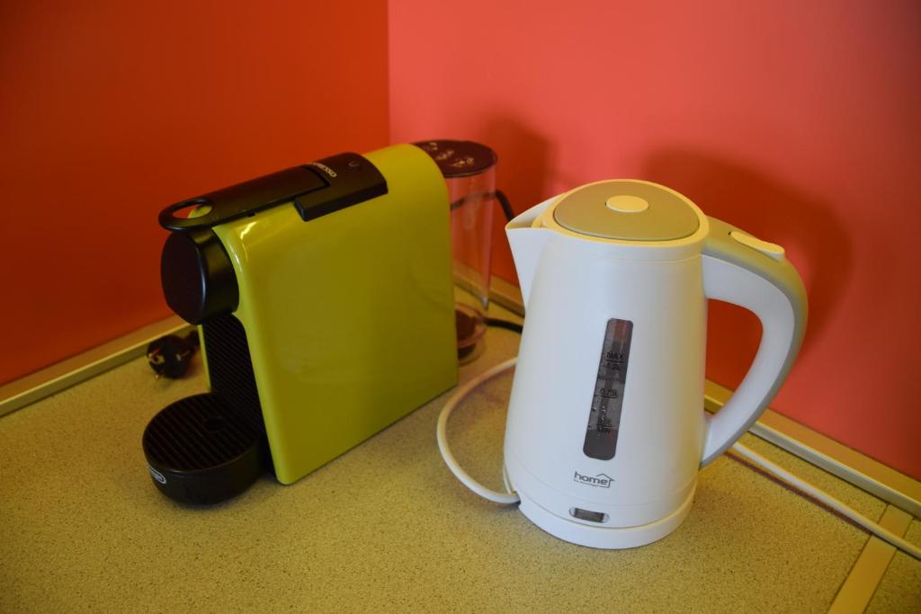 a kitchen counter with a coffee maker and a blender at Panorama Apartman in Velence