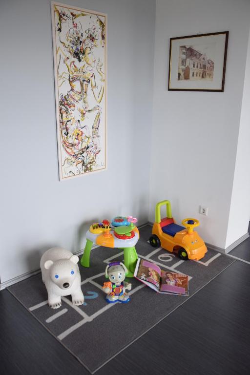 a group of toys on the floor in a room at Panorama Apartman in Velence