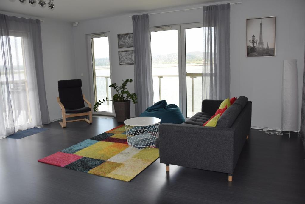 a living room with a couch and a rug at Panorama Apartman in Velence