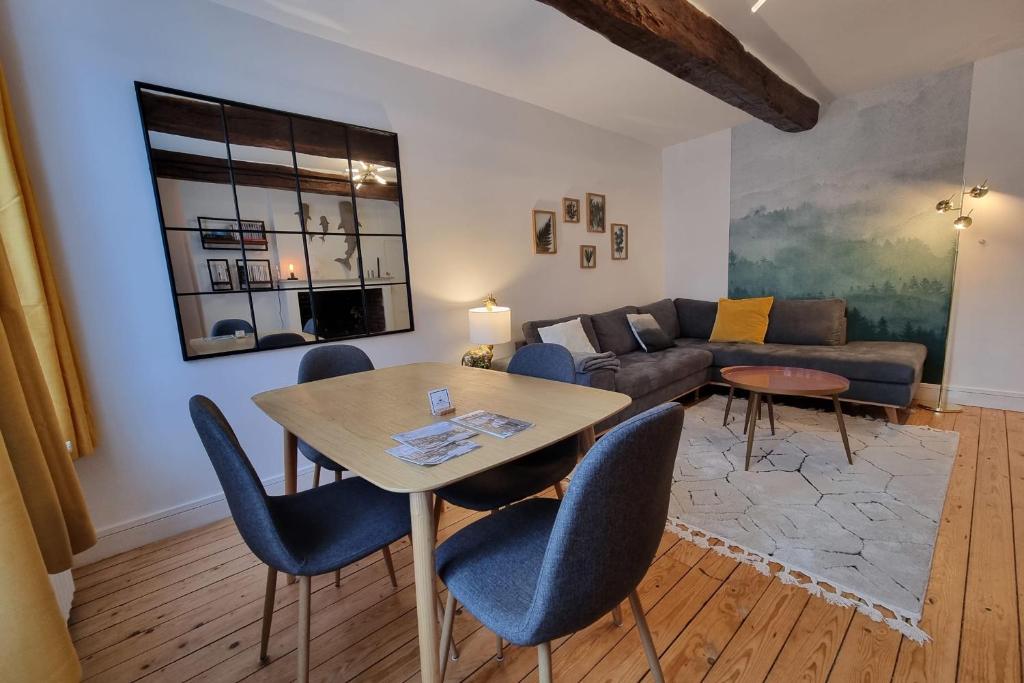 a living room with a table and chairs and a couch at La Cabane de Milo - Typical Honfleur fisherman's house - 2 bedrooms in Honfleur