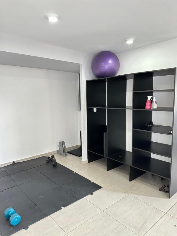a room with black shelves and a purple ball on the wall at Apartamento Amoblado Luxury Excelente Ubicacion in Cúcuta