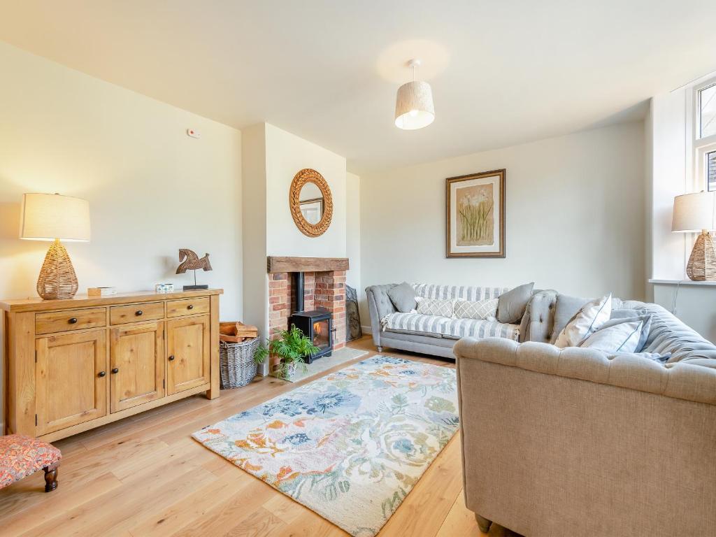 a living room with a couch and a fireplace at Avondale in Woodgreen