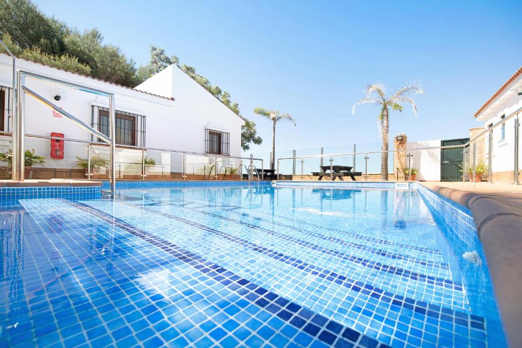a swimming pool with blue tiles on a building at Novobarrosa A in Chiclana de la Frontera