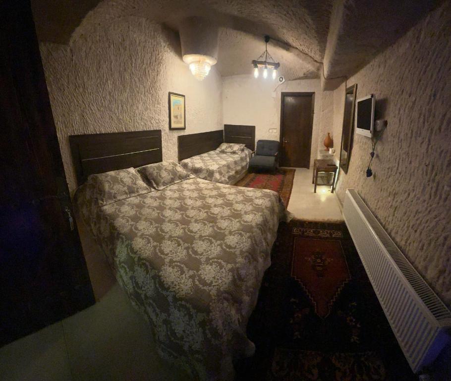 Postel nebo postele na pokoji v ubytování Uchisar Cave House