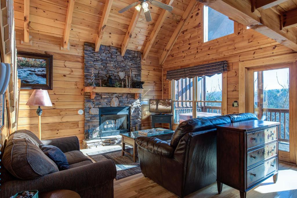 a living room with a couch and a fireplace at Aspen's Envy, 4 Bedrooms, Sleeps 16, Pool Table, Hot Tub, Mountain Views in Pigeon Forge