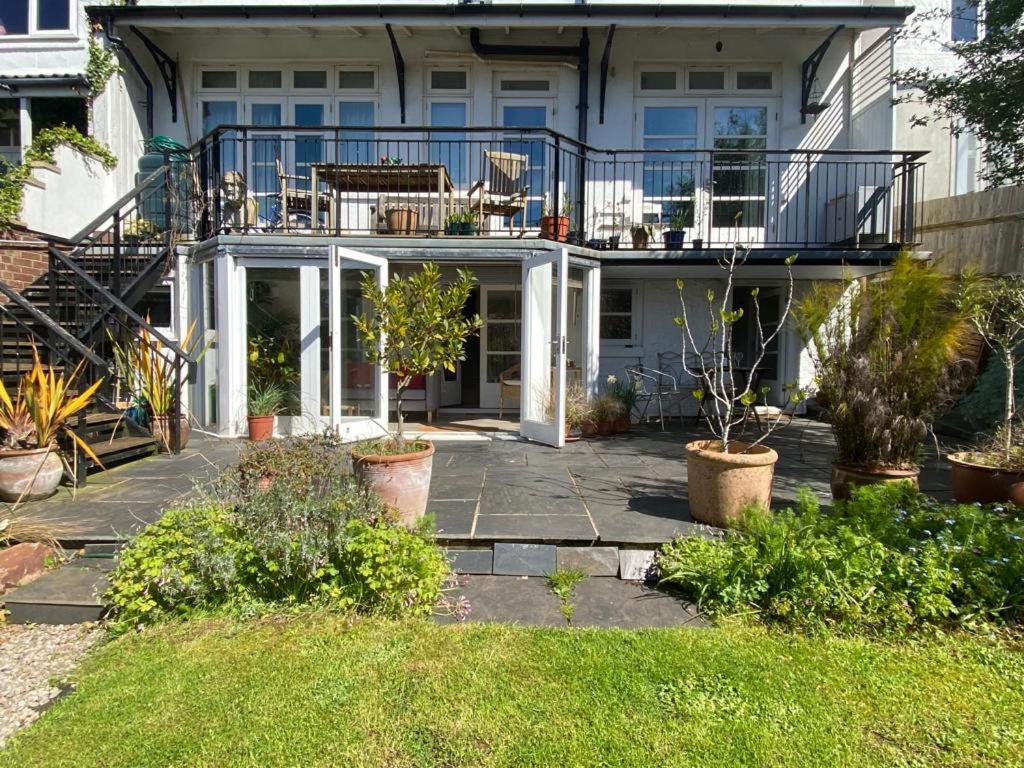 a house with an enclosed patio with plants at Clifton garden flat with parking in Bristol