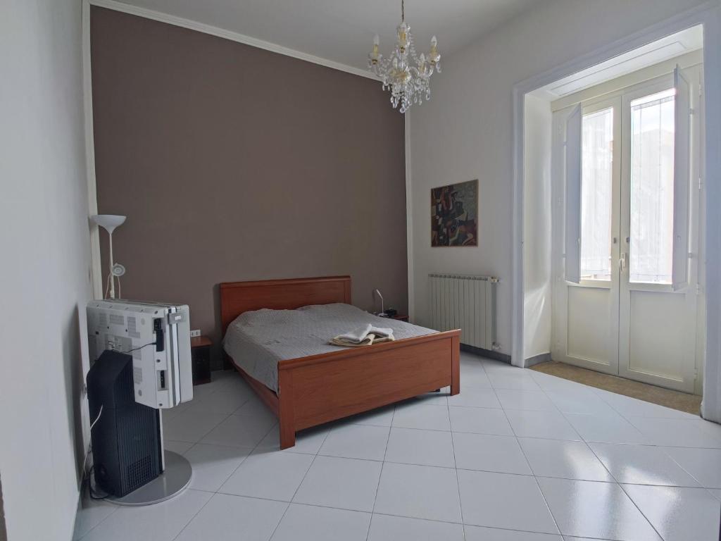 a bedroom with a bed and a television in it at ReggiaHome Apartment in Caserta