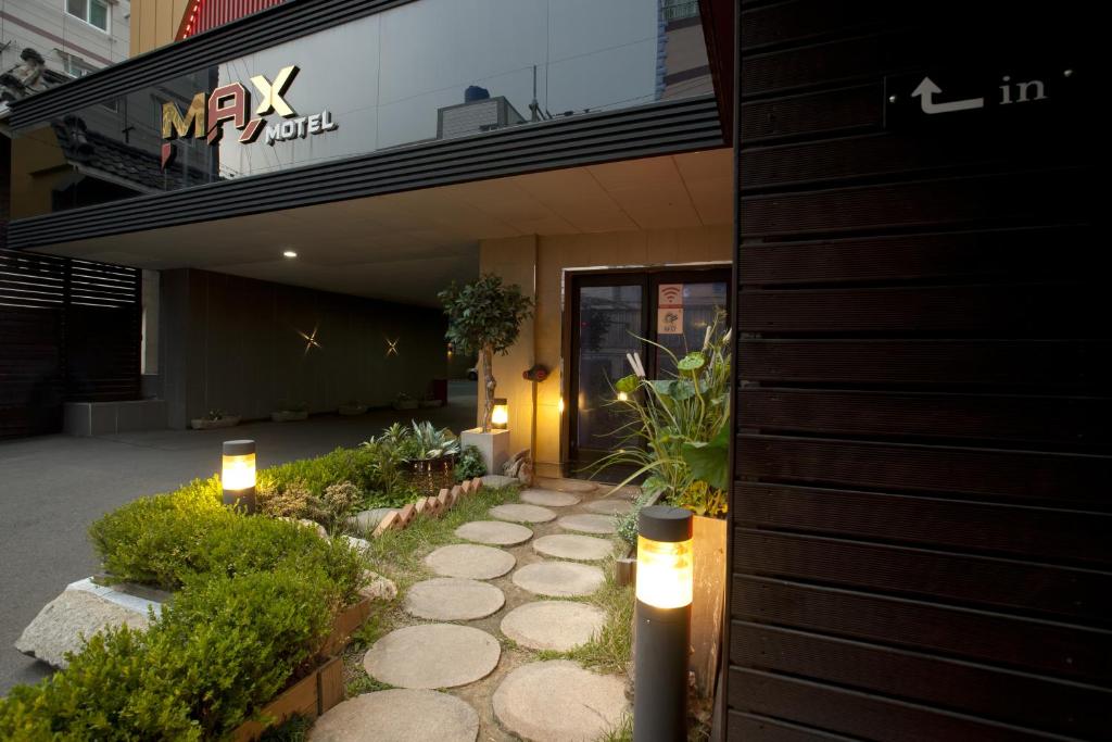 a walkway in front of a building with lights at Max Motel - Sasang in Busan