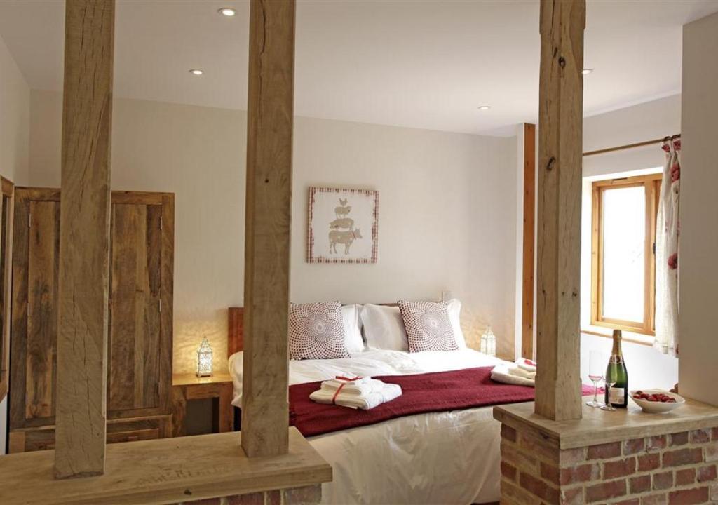 a bedroom with a large bed with wooden beams at Partridge in Saint James