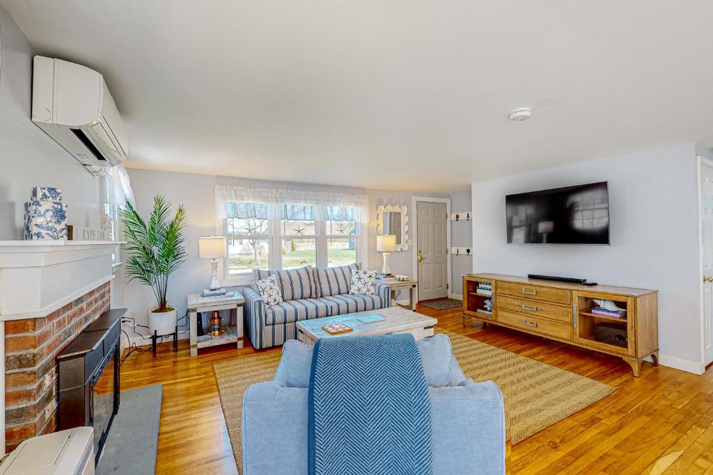a living room with a couch and a tv at Far Away by the Sea in Yarmouth