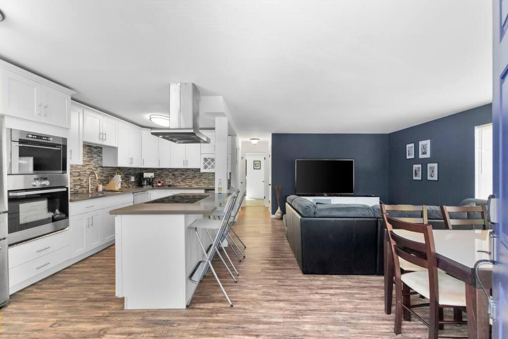 a kitchen with white cabinets and a blue wall at Epicurean remodel in central location. in Seattle