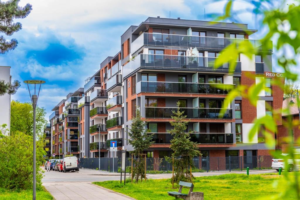 an apartment building with balconies on a city street at Premium Wrocławska Apartament Parking in Bydgoszcz