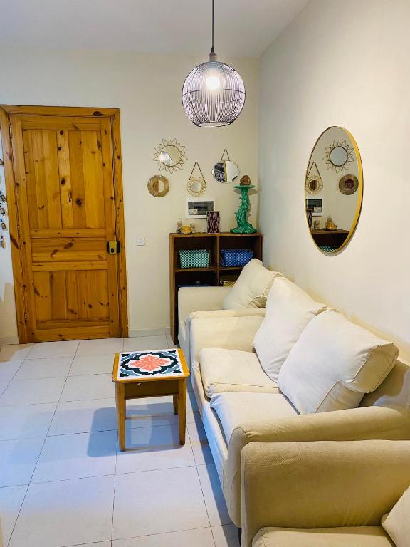 a living room with a couch and a table at the valley in Il-Gżira