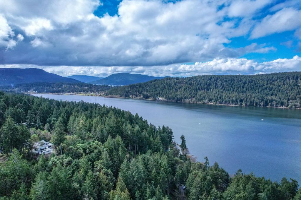 an aerial view of a lake with trees at Salt Spring Carriage House B&B in Ganges