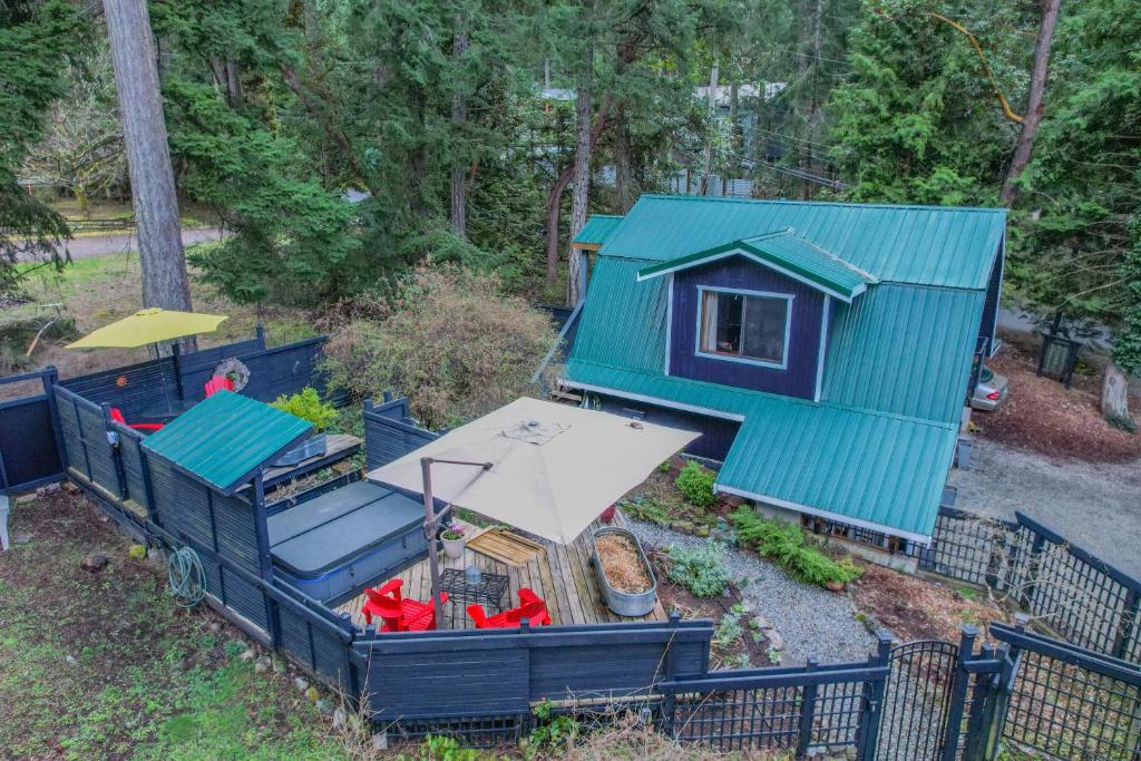 an aerial view of a play house with a blue roof at Salt Spring Carriage House B&B in Ganges