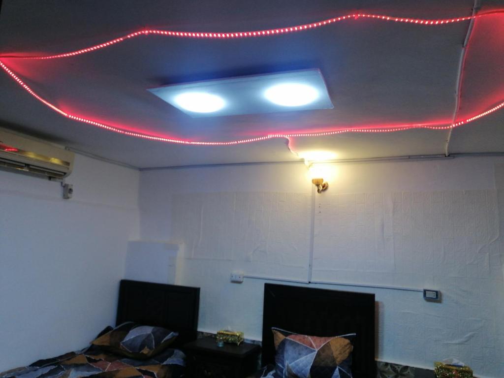 a room with a red light on the ceiling at Elegant housing in Jerash