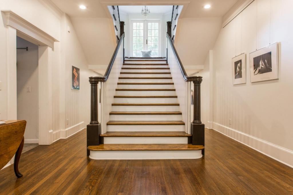 a staircase in a home with wooden floors at Roanoke at Oak Street Mansion in Kansas City