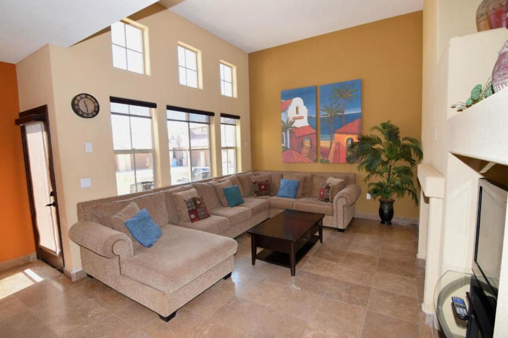 a living room with two couches and a fireplace at Super close to the beach house for rent in San Felipe - FREE WiFi + Golf Pass in La Ponderosa