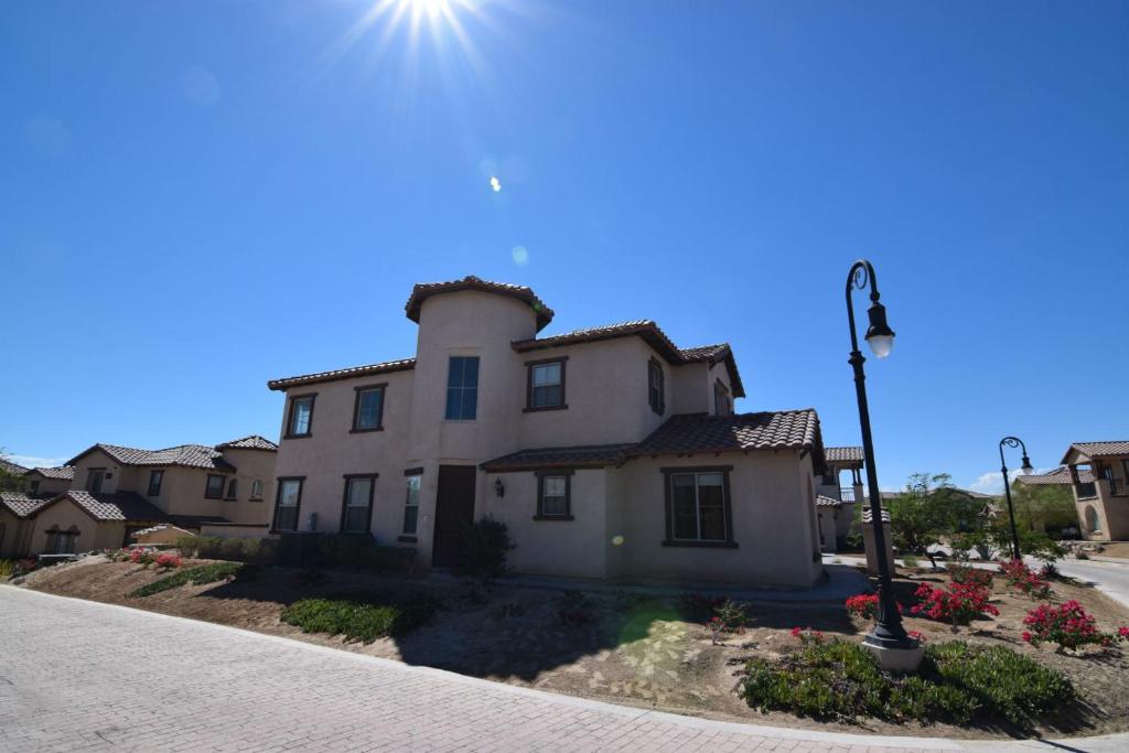 a white house with the sun in the sky at San Felipe Ultra Deluxe Elegance with Spectacular Sea Views in Playa El Paraíso