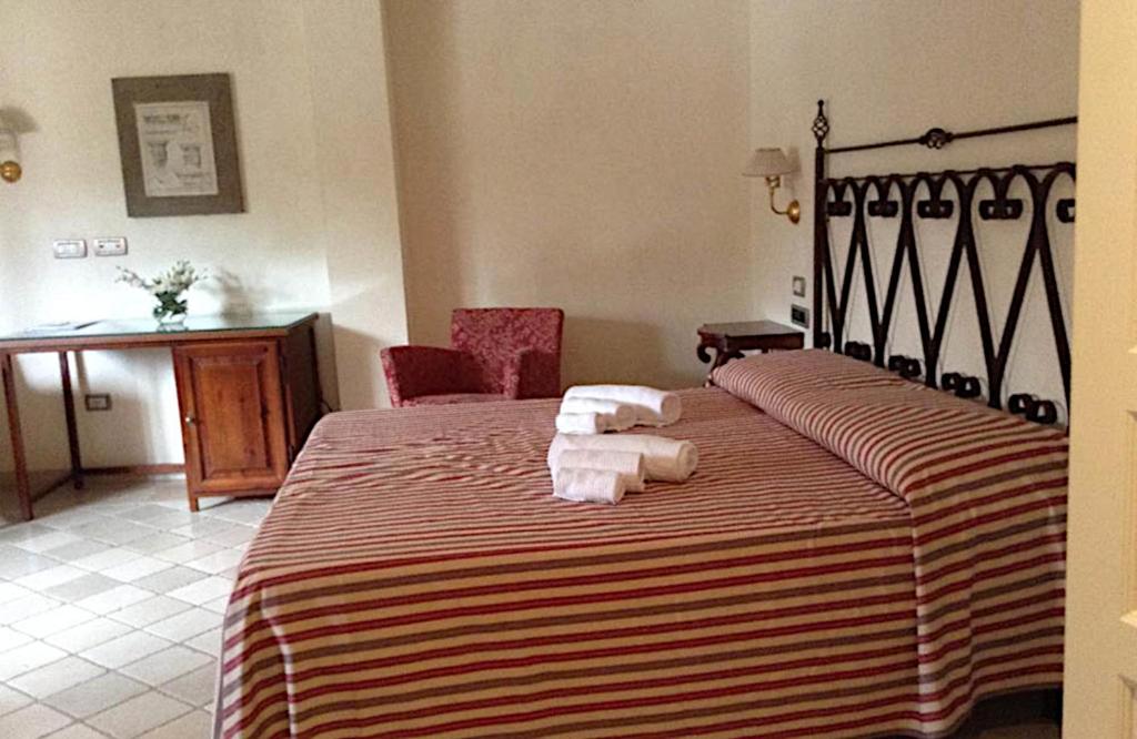 Łóżko lub łóżka w pokoju w obiekcie Relais Sant'Eligio