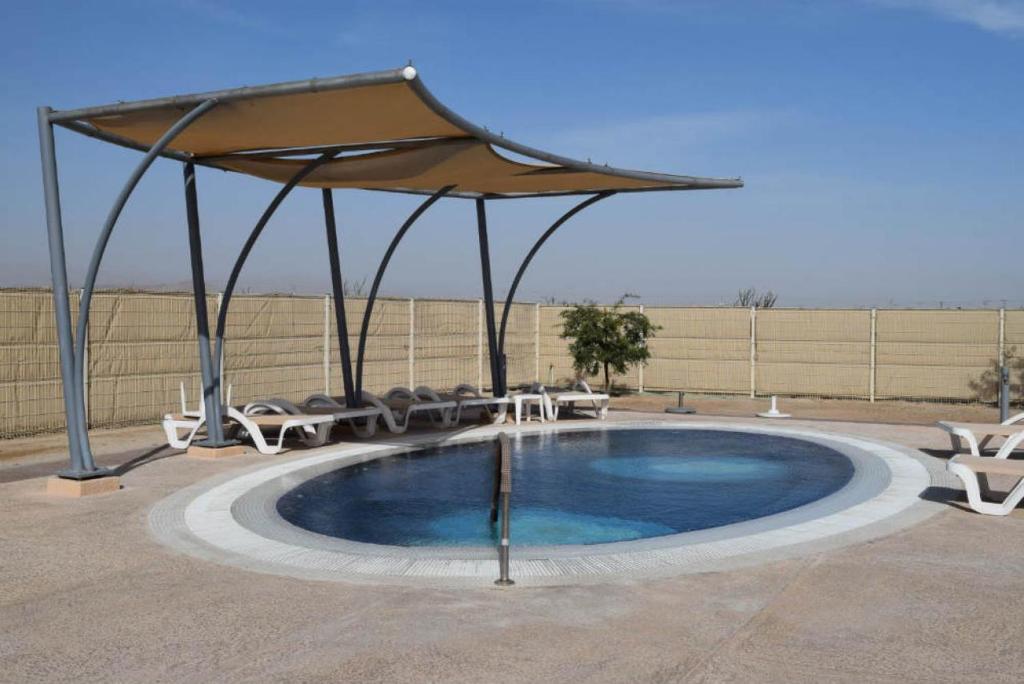 una piscina con ombrellone, sedie e tavolo di Casa Palos Verdes Rental El Dorado Ranch San Felipe a San Felipe