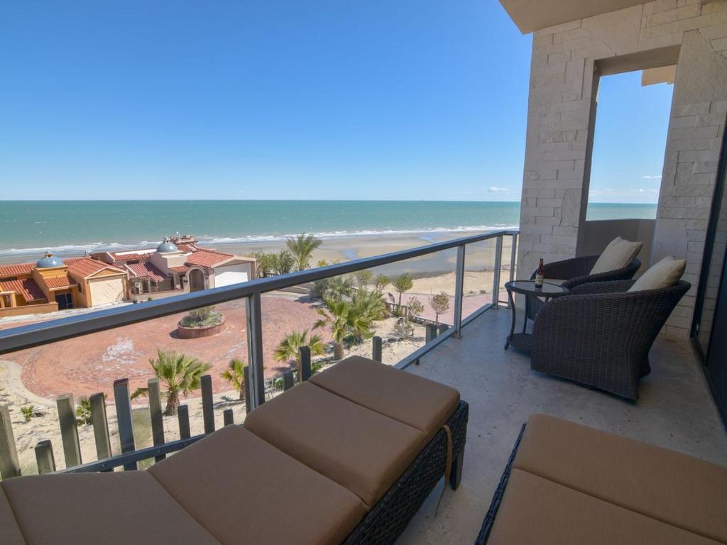 a balcony with chairs and a view of the beach at La Hacienda San Felipe Mexico Vacation Rental in San Felipe