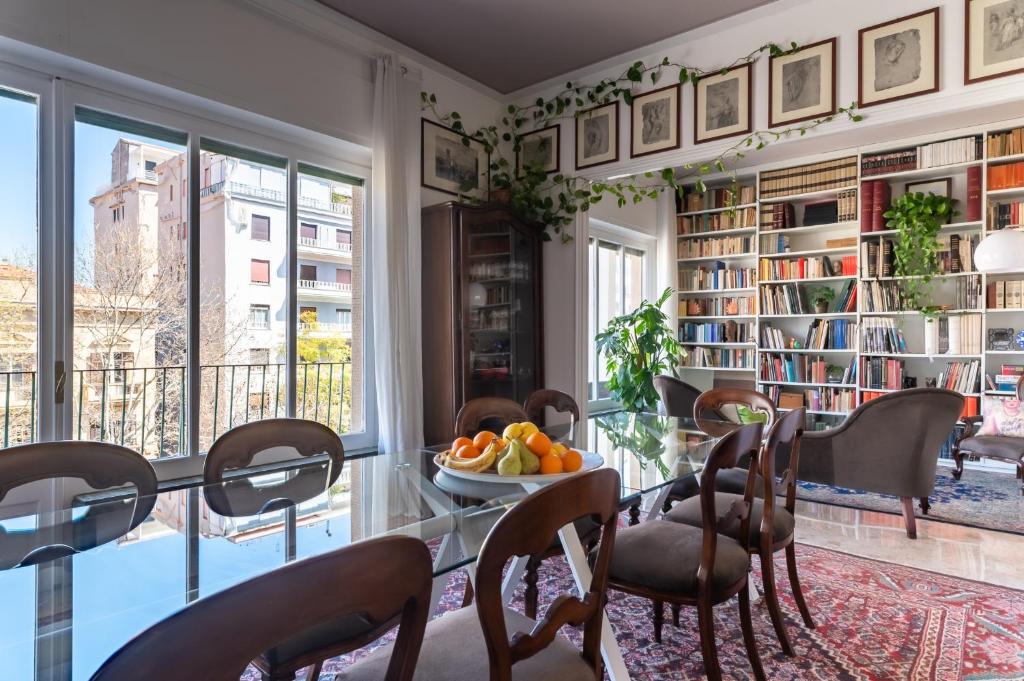 a dining room with a table with a bowl of fruit at Libertà #102 - Guest House Palermo in Palermo