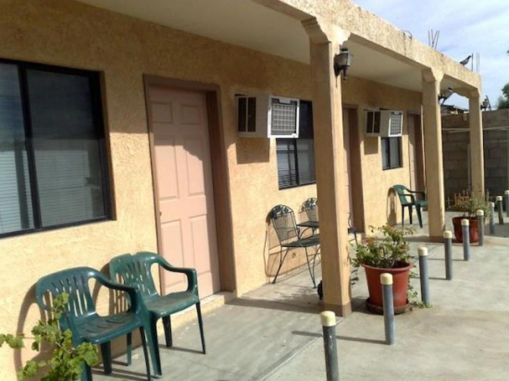 a porch with chairs and tables and a door at San Felipe Rental Studio #1 Free WiFi and Cable TV in San Felipe