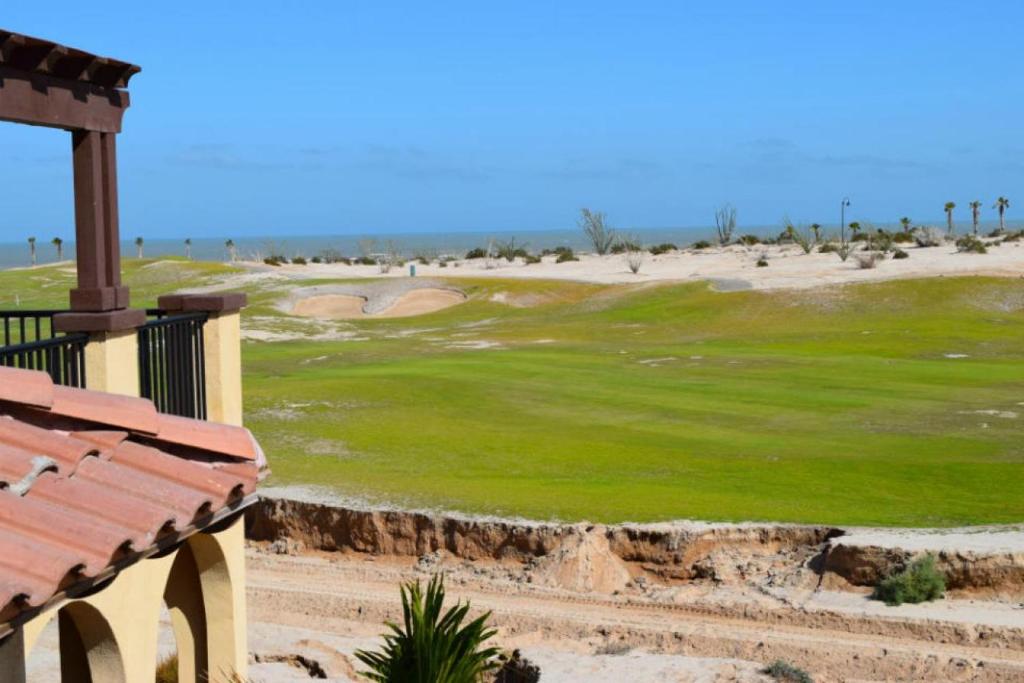 a view of a golf course with a green at Beautiful El Dorado Ranch Vacation Rental Condo in San Felipe