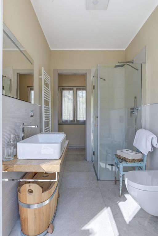 a bathroom with a tub and a sink and a shower at Ciabot delle Aie - Barolo in Barolo
