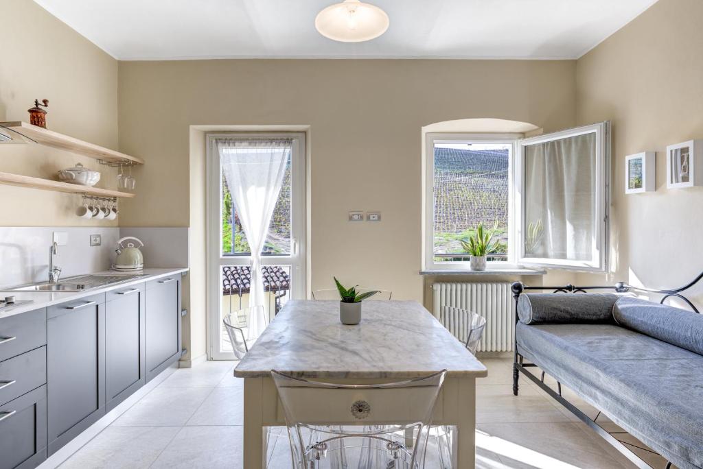 a kitchen and living room with a couch and a table at Ciabot delle Aie - Barolo in Barolo