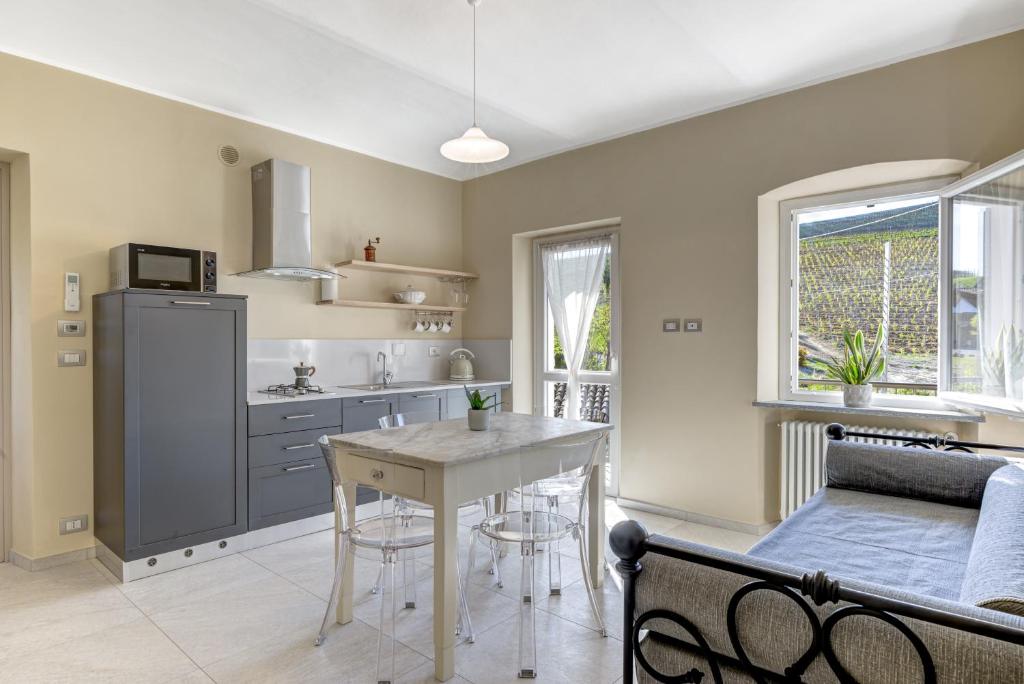 a kitchen and dining room with a table and chairs at Ciabot delle Aie - Barolo in Barolo