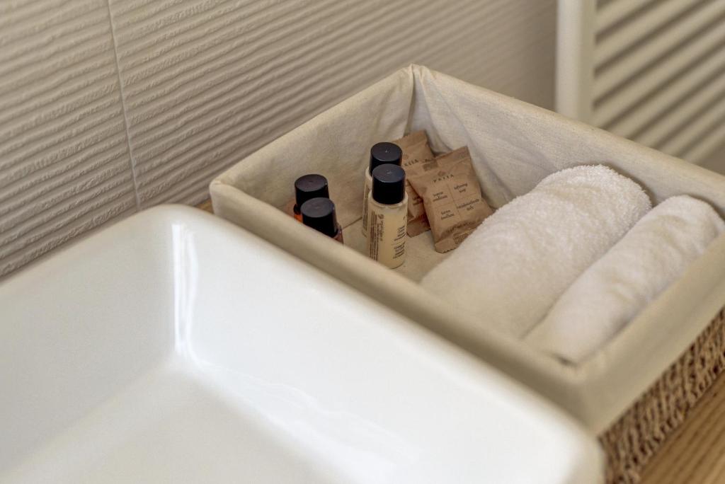 a bathroom with a sink and towels and a tub at Ciabot delle Aie - Barolo in Barolo