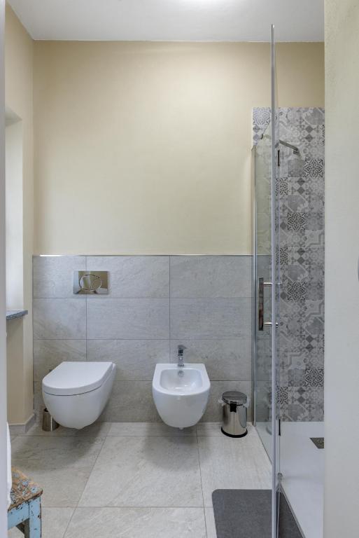 a bathroom with a toilet and a sink and a shower at Ciabot delle Aie - Barolo in Barolo