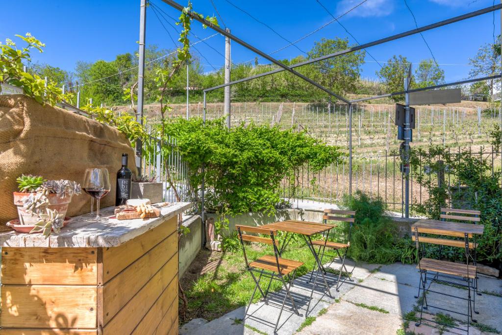a small patio with a table and chairs at Ciabot delle Aie - Barolo in Barolo