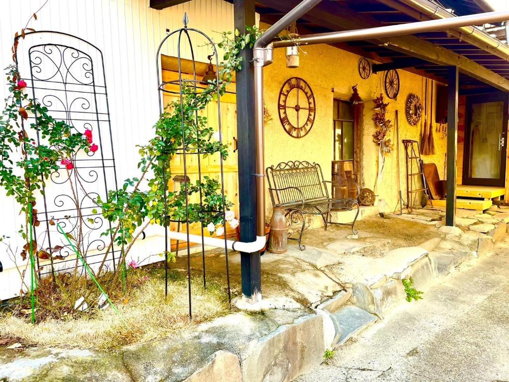 a bench sitting outside of a house with a building at vintagehouse1925Bali - Vacation STAY 14503 in Nagano