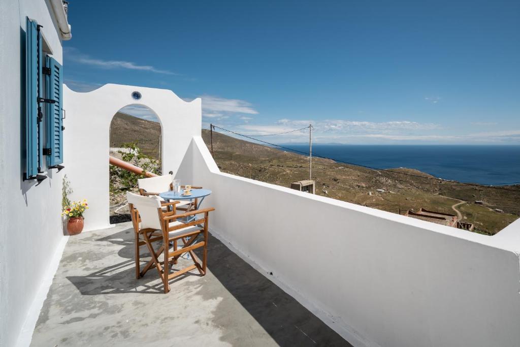 a balcony with a table and a view of the ocean at Alcyone in Serifos Chora
